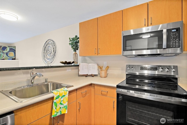 107 20th Ave Unit 306, Seattle, WA 98122 - kitchen with stainless steel appliances, a sink, and light countertops