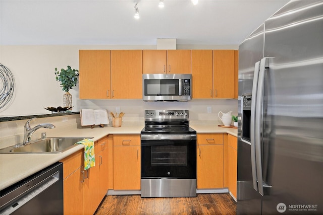 107 20th Ave Unit 306, Seattle, WA 98122 - kitchen with stainless steel appliances, a sink, light countertops, and dark wood-style floors