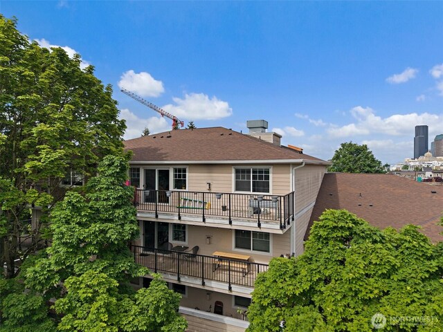 107 20th Ave Unit 306, Seattle, WA 98122 - rear view of house featuring a balcony and a shingled roof