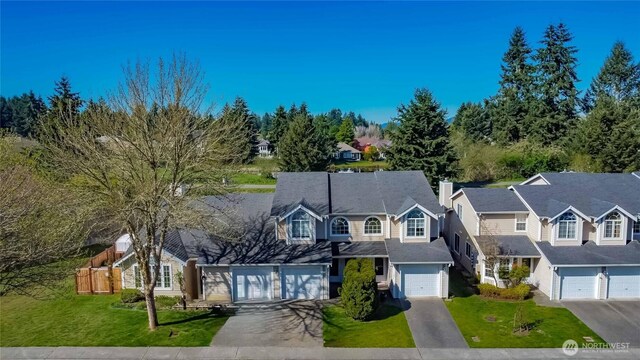 6049 Merlot Ln SE, Lacey, WA 98513 - view of front facade featuring a front lawn, a chimney, concrete driveway, an attached garage, and a residential view