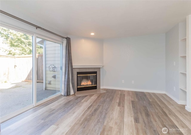 6049 Merlot Ln SE, Lacey, WA 98513 - unfurnished living room featuring built in features, wood finished floors, baseboards, recessed lighting, and a tile fireplace