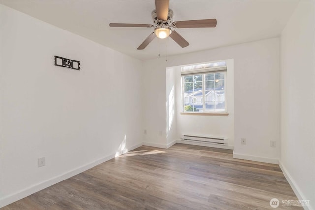 6049 Merlot Ln SE, Lacey, WA 98513 - unfurnished room featuring wood finished floors, baseboards, ceiling fan, and a baseboard heating unit