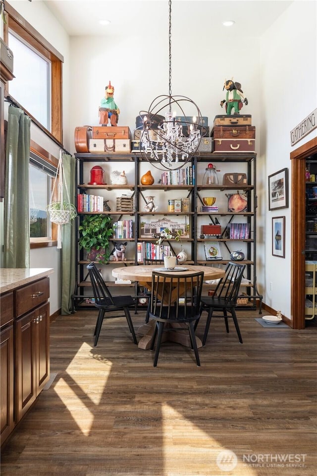 dining space with baseboards, a chandelier, recessed lighting, and dark wood-type flooring