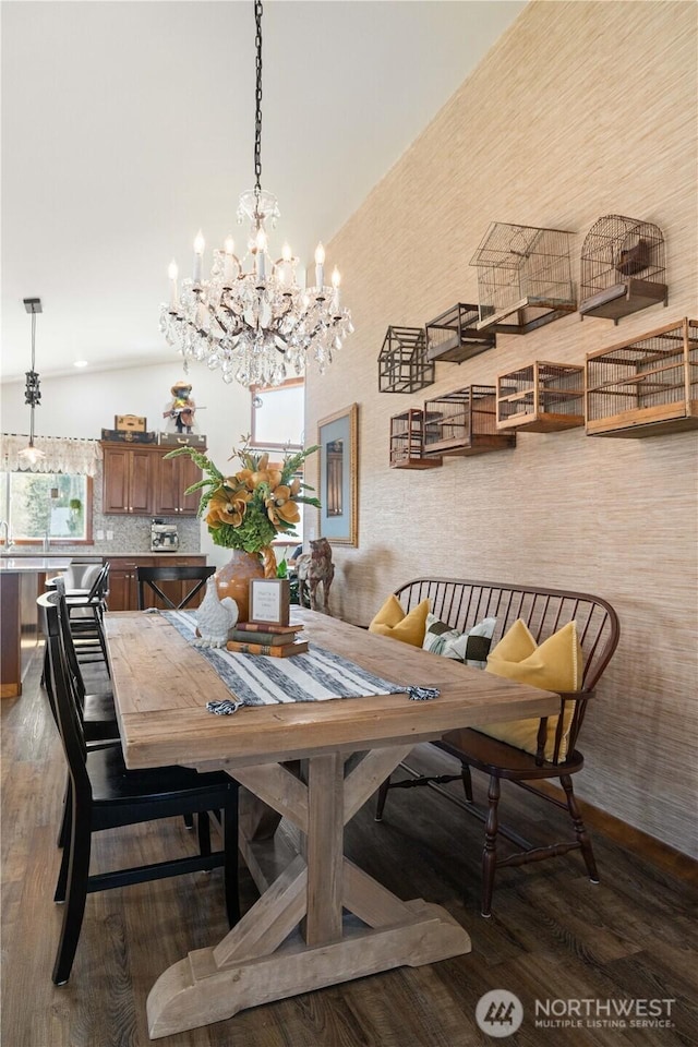 dining room with plenty of natural light, wood finished floors, and an inviting chandelier