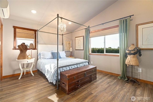 bedroom featuring wood finished floors, baseboards, and a wall mounted AC