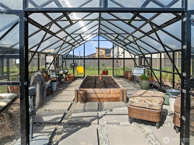 view of patio featuring an exterior structure, a garden, an outbuilding, and fence