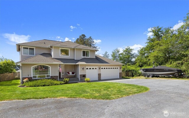 664 Lactrup Spur Ln, Camano Island, WA 98282 - traditional-style house featuring fence, an attached garage, driveway, and a front lawn