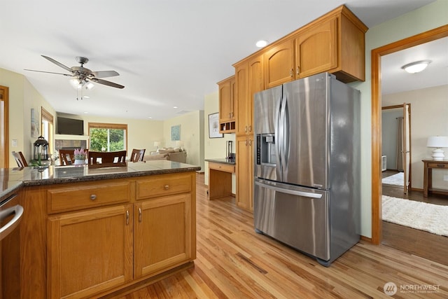 664 Lactrup Spur Ln, Camano Island, WA 98282 - kitchen with light wood-style floors, stainless steel fridge with ice dispenser, a ceiling fan, and open floor plan