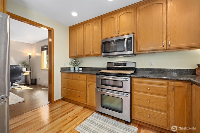 664 Lactrup Spur Ln, Camano Island, WA 98282 - kitchen featuring recessed lighting, brown cabinetry, light wood-style flooring, and appliances with stainless steel finishes