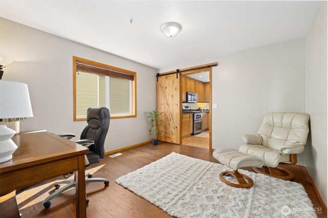 664 Lactrup Spur Ln, Camano Island, WA 98282 - office area with light wood-style floors, baseboards, a barn door, and visible vents