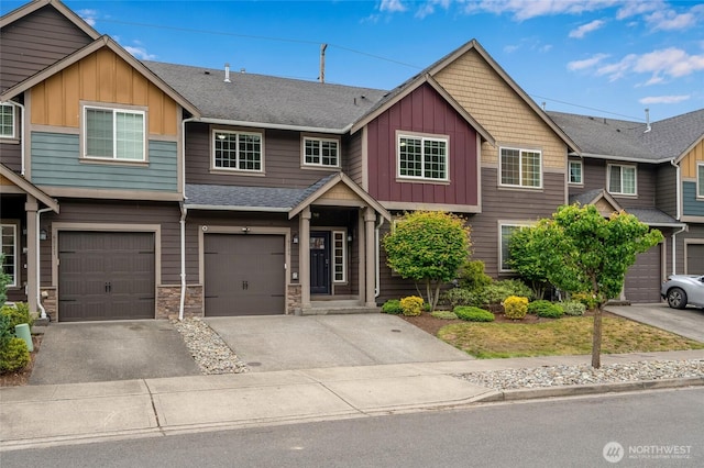 townhome / multi-family property featuring board and batten siding, driveway, a garage, a shingled roof, and stone siding