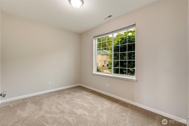 empty room with baseboards and carpet