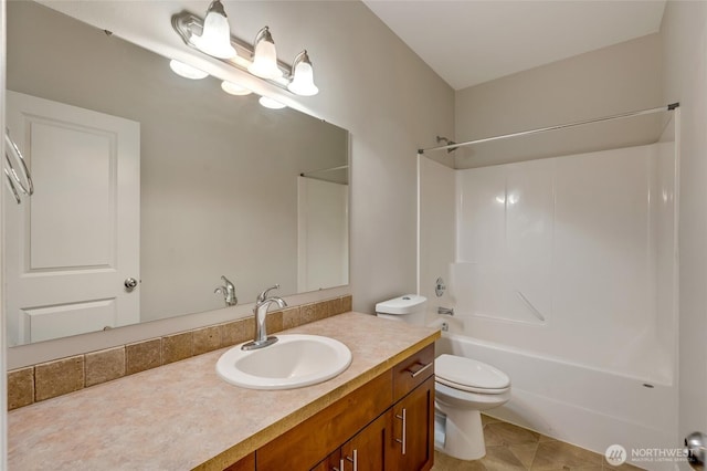 bathroom featuring toilet, vanity, and shower / washtub combination