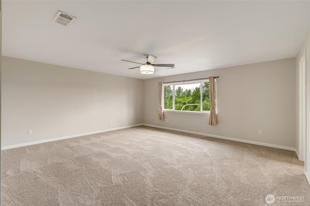 empty room with ceiling fan, baseboards, and carpet floors
