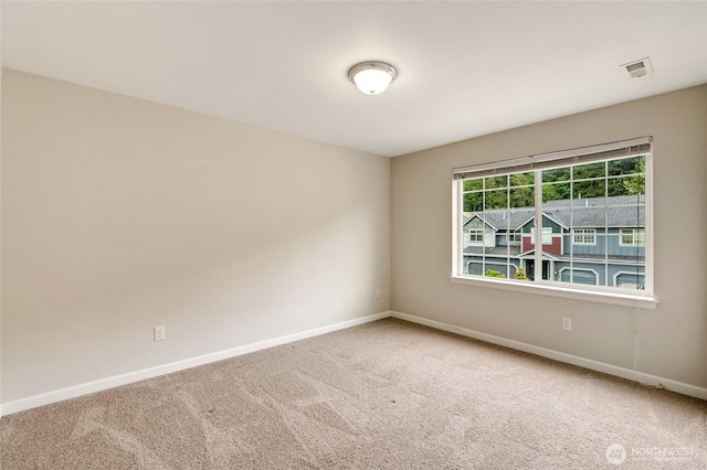 carpeted empty room with baseboards
