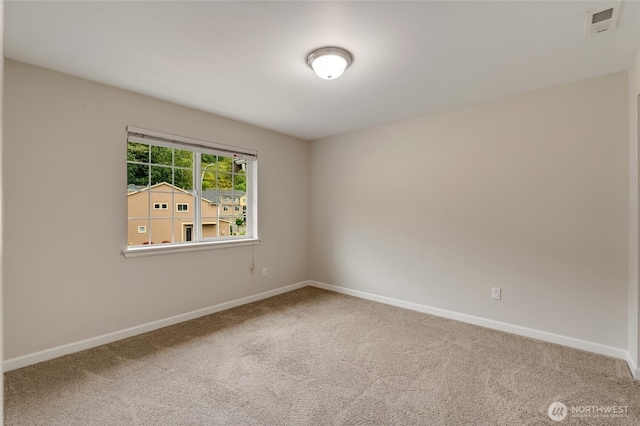 spare room with baseboards and carpet floors