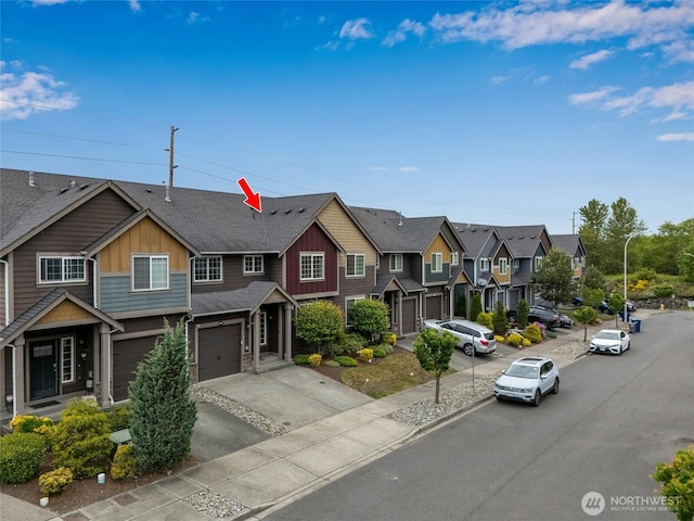 townhome / multi-family property featuring board and batten siding, a residential view, a garage, driveway, and a shingled roof