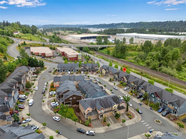 aerial view of property's location with nearby suburban area and a tree filled landscape