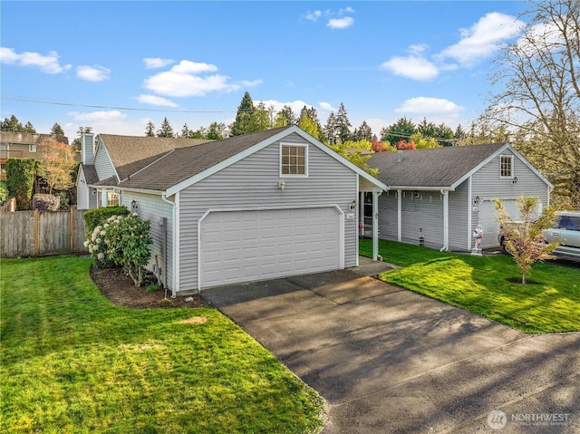 ranch-style house with fence, an attached garage, a front lawn, and aphalt driveway
