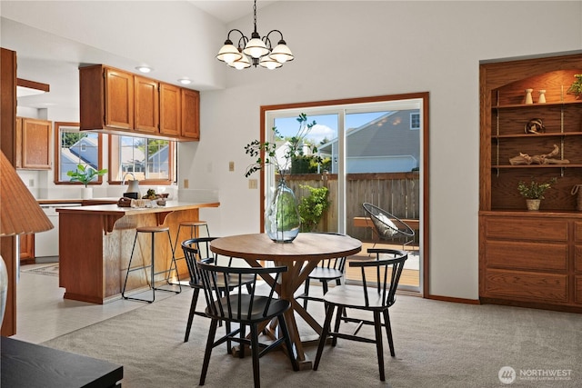 dining area featuring a wealth of natural light, lofted ceiling, and a chandelier