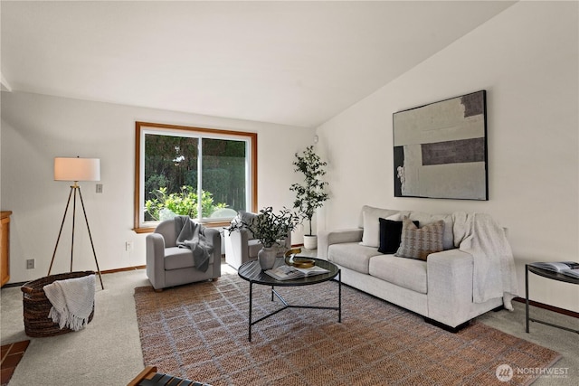 carpeted living room featuring baseboards and vaulted ceiling