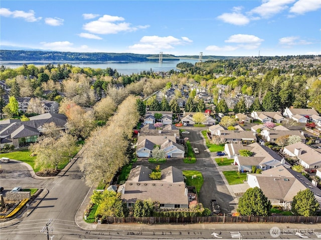 drone / aerial view with a water view and a residential view