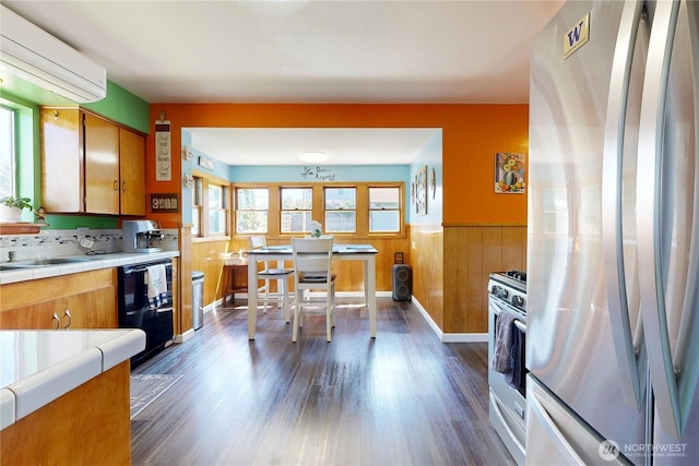 138 SE 5th Ave, Milton-Freewater, OR 97862 - kitchen with stainless steel appliances, wainscoting, brown cabinets, dark wood-type flooring, and tile counters