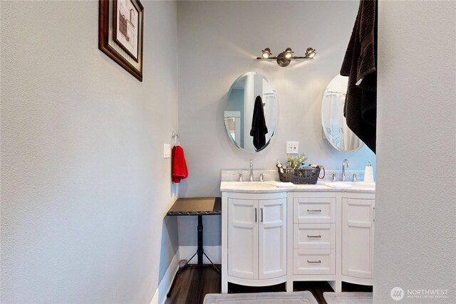 138 SE 5th Ave, Milton-Freewater, OR 97862 - bathroom with double vanity, wood finished floors, and baseboards