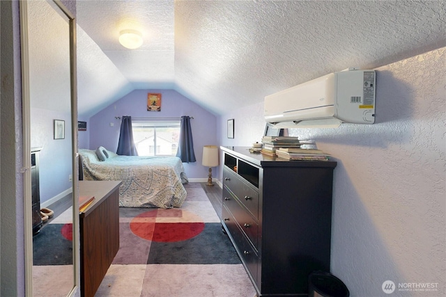 138 SE 5th Ave, Milton-Freewater, OR 97862 - bedroom with a wall mounted AC, a textured ceiling, vaulted ceiling, a textured wall, and dark colored carpet