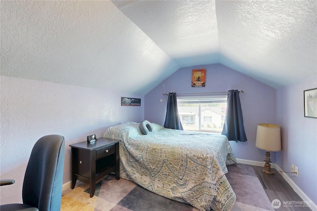 138 SE 5th Ave, Milton-Freewater, OR 97862 - bedroom with a textured ceiling, vaulted ceiling, baseboards, and wood finished floors