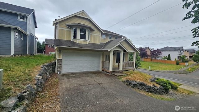 704 7th Ave SW, Tumwater, WA 98512 - view of front of property with a garage, a porch, asphalt driveway, a front yard, and board and batten siding