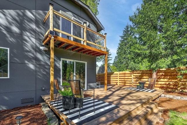 wooden terrace with fence and visible vents