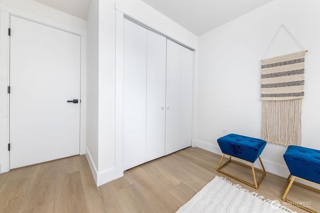 sitting room with light wood-type flooring and baseboards