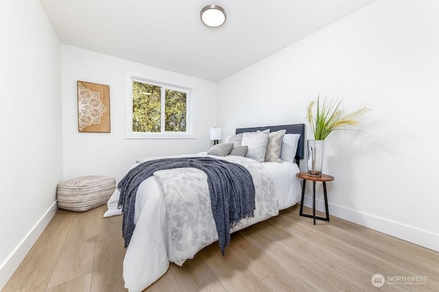 bedroom featuring baseboards and wood finished floors