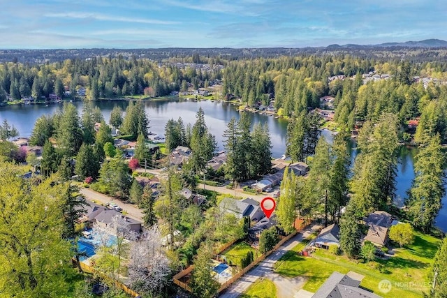 drone / aerial view with a view of trees and a water view