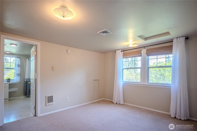 unfurnished room with light colored carpet, baseboards, and visible vents