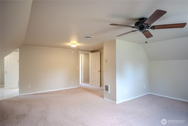 bonus room with light colored carpet, a ceiling fan, and visible vents
