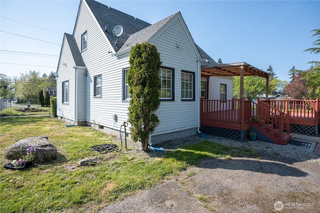 view of side of home featuring a yard, a deck, a shingled roof, and a pergola