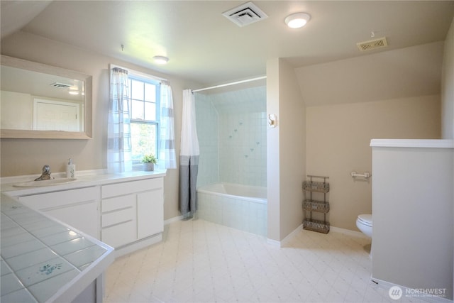 full bathroom featuring visible vents, tile patterned floors, tiled shower / bath combo, and toilet