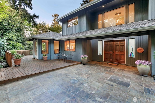 entrance to property with roof with shingles