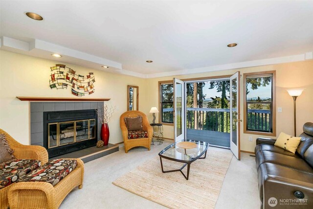carpeted living room with recessed lighting, a fireplace, and baseboards