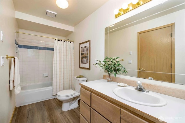 bathroom featuring toilet, wood finished floors, vanity, and shower / bath combination with curtain