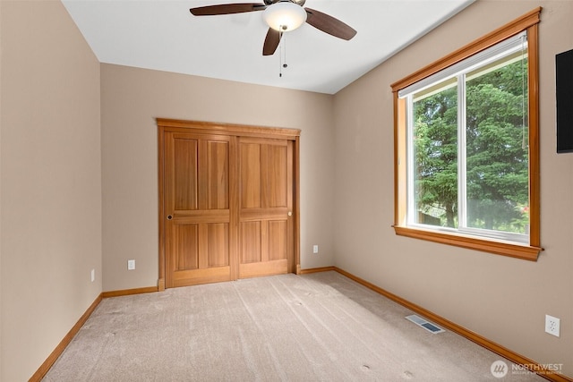 2111 Huntington Loop SE, Olympia, WA 98513 - unfurnished bedroom featuring light colored carpet, baseboards, and ceiling fan