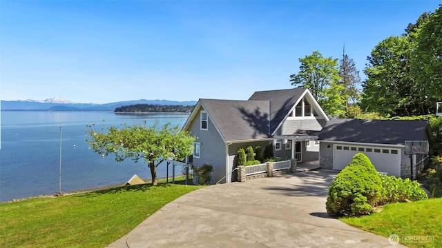250 Fay Ln, Camano Island, WA 98282 - view of front facade featuring a water and mountain view, an attached garage, and driveway