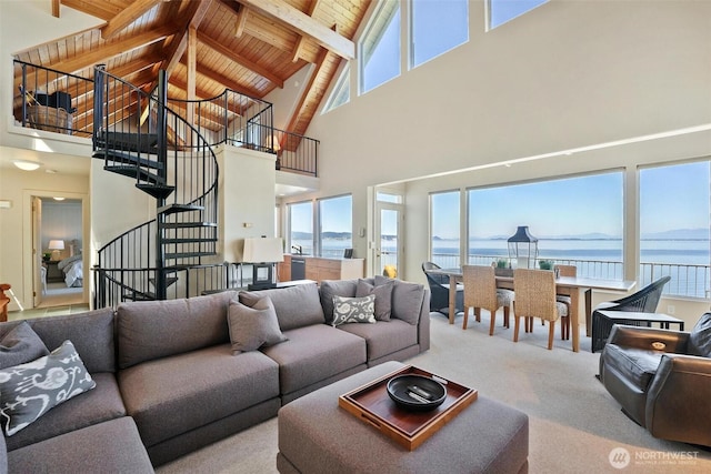 250 Fay Ln, Camano Island, WA 98282 - carpeted living room with stairs, beam ceiling, high vaulted ceiling, a water view, and wooden ceiling