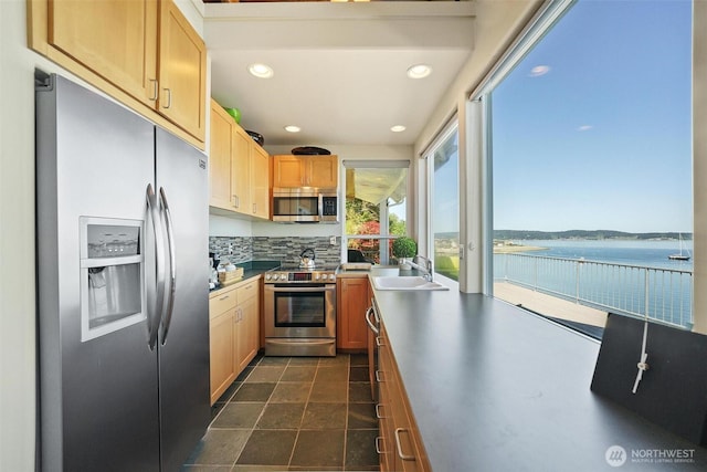 250 Fay Ln, Camano Island, WA 98282 - kitchen featuring recessed lighting, a water view, a sink, appliances with stainless steel finishes, and backsplash