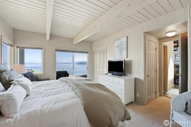 250 Fay Ln, Camano Island, WA 98282 - bedroom featuring wood walls, beamed ceiling, light carpet, and access to exterior