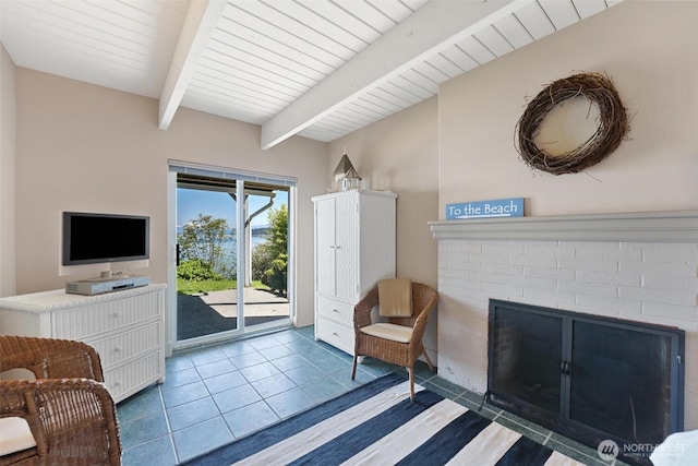 250 Fay Ln, Camano Island, WA 98282 - living area with tile patterned flooring, a brick fireplace, and beam ceiling