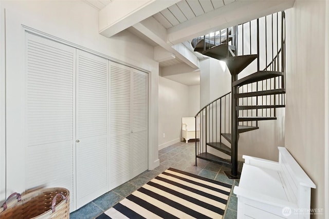 250 Fay Ln, Camano Island, WA 98282 - stairway with baseboards, beamed ceiling, and stone tile floors