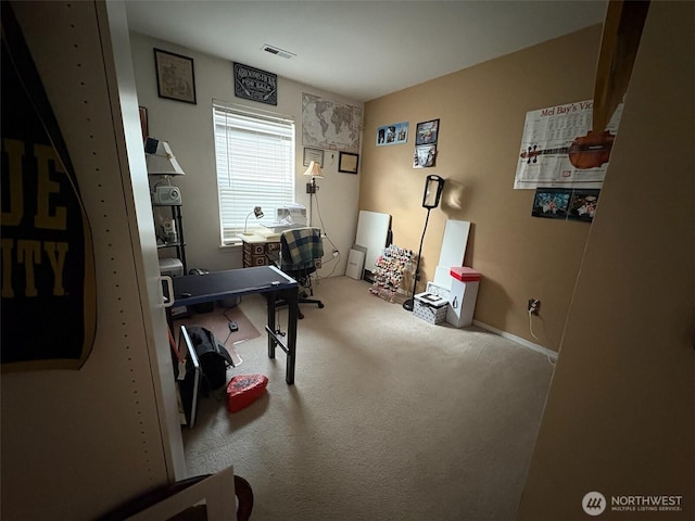office area featuring carpet floors, baseboards, and visible vents